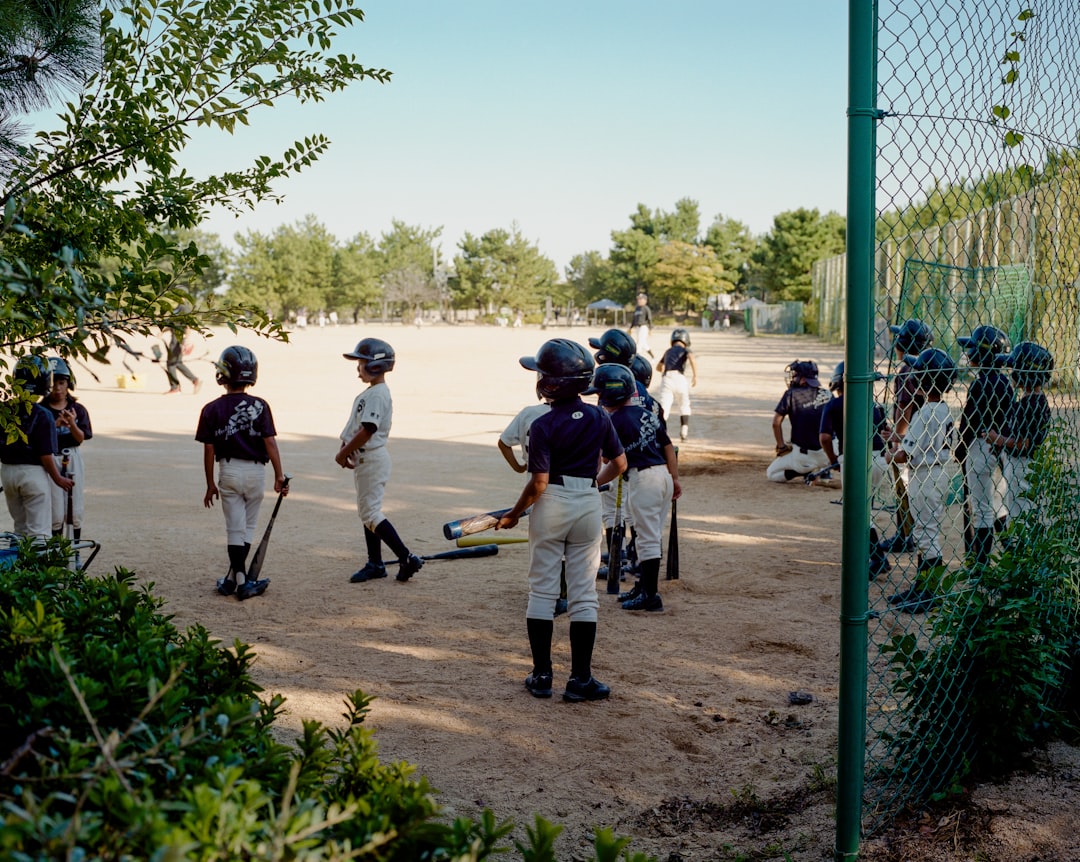 A group of young baseball players standing next to each other baseball academy training, Dominican Republic teenagers, outdoor baseball field