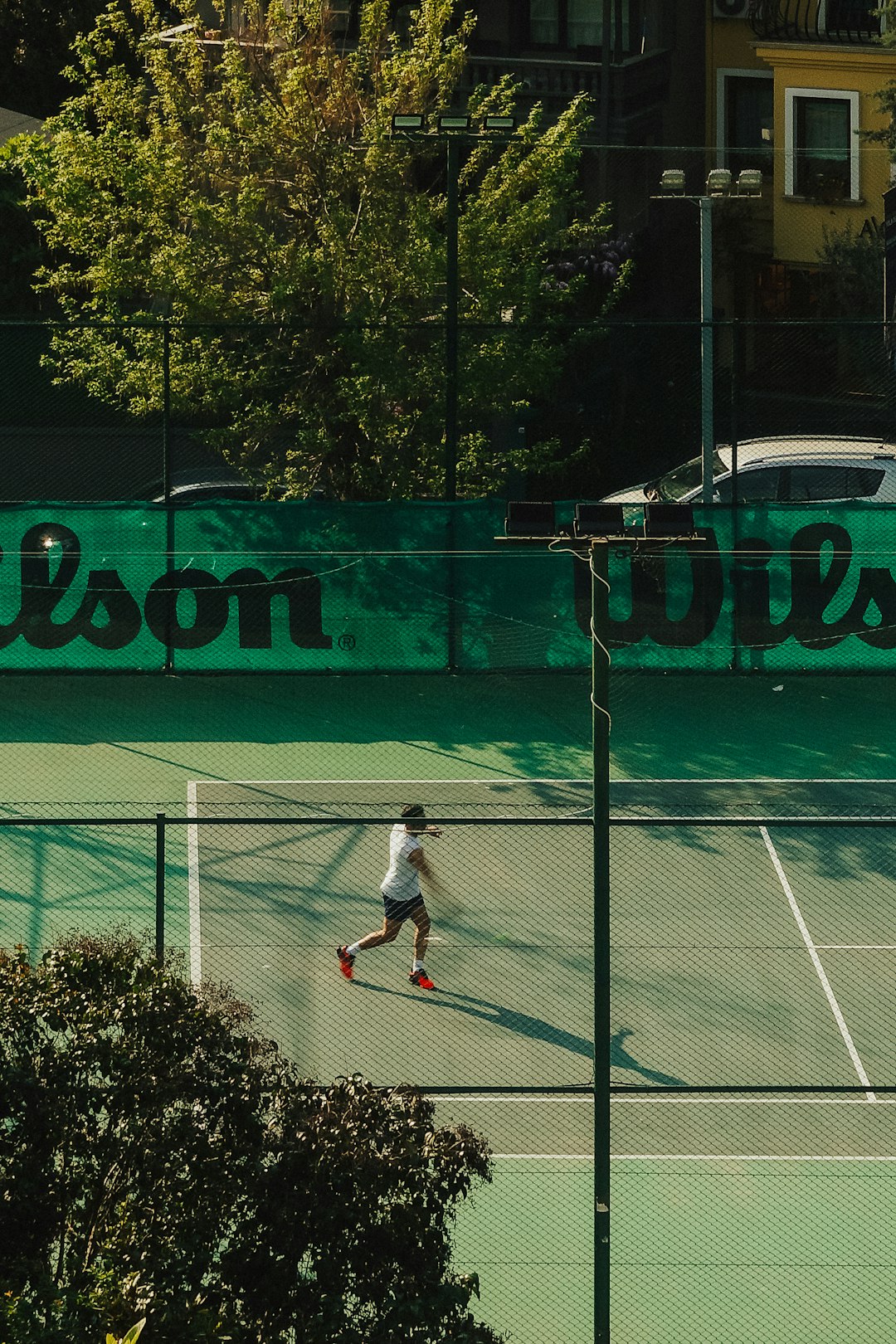 a man on a tennis court holding a racquet university of georgia tennis court,tennis match,college tennis