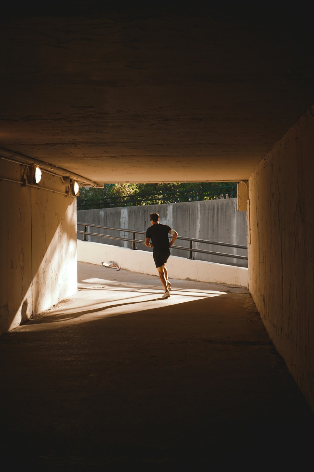 a man running in a tunnel under a bridge running back touchdown