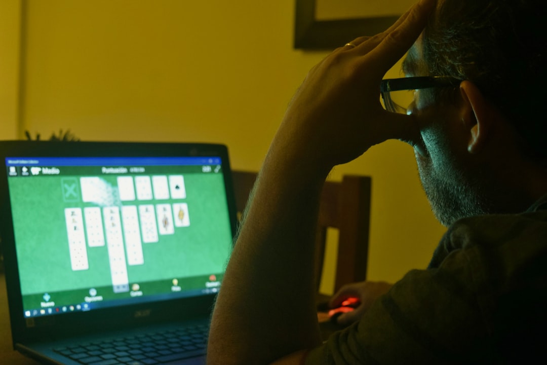 a man sitting in front of a laptop computer football manager 2024, gaming, editor