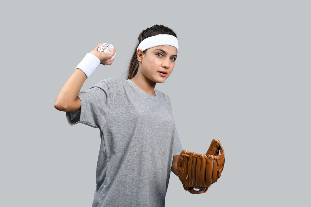 a person wearing a baseball glove kid trying on baseball glove, youth baseball equipment, sports practice gear