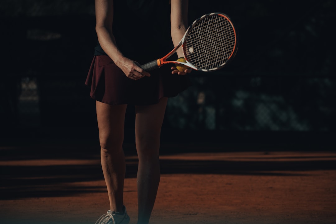 a woman holding a tennis racket female tennis players,match in progress,college tennis players
