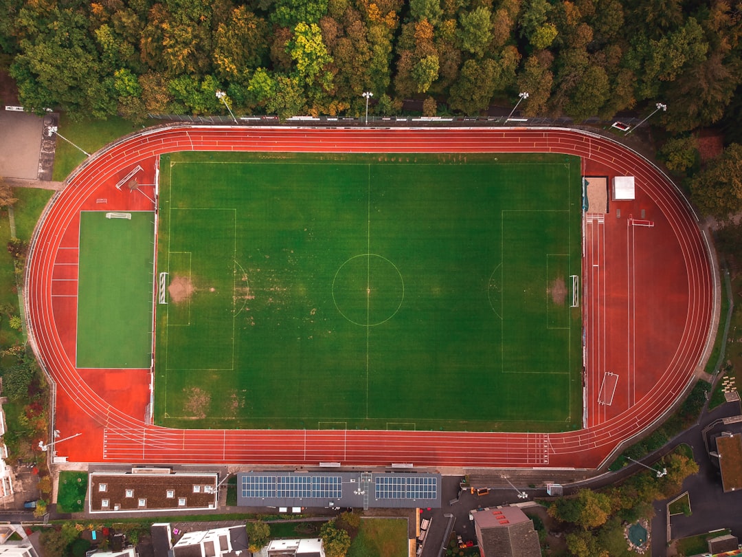 aerial view of green and red soccer field football field red zone