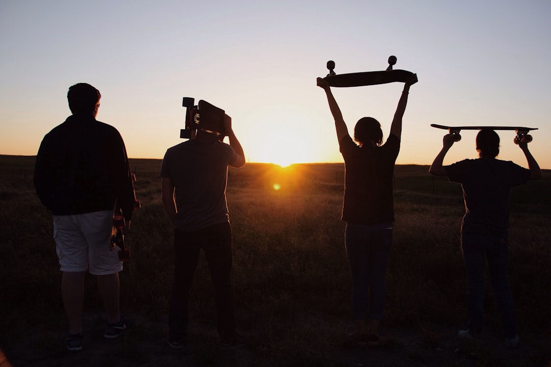 group of people holding skateboards under sunset baseball gloves shopping, sports store, youth baseball equipment