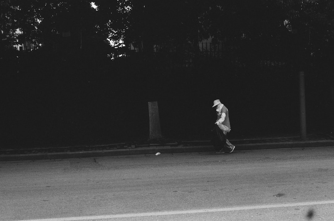 man in black jacket walking on the street running back touchdown