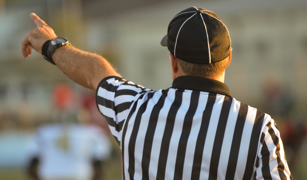 man pointing his finger during daytime football referee, official timeout, american football game