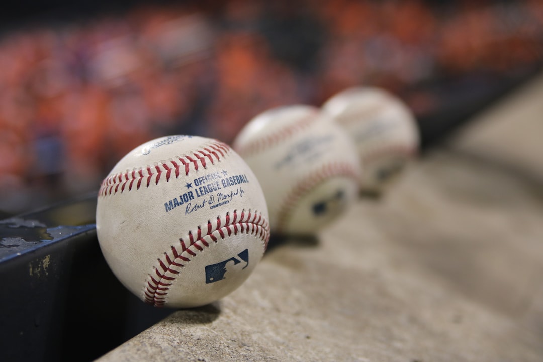 three white baseballs on gray textile baseball academy training, Dominican Republic teenagers, outdoor baseball field