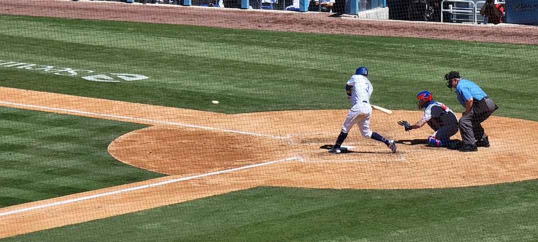 a baseball player swinging a bat at a ball baseball hitter batting swing stadium