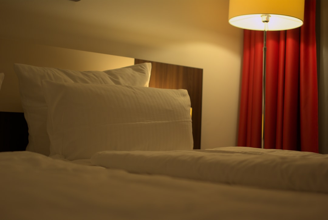 a bed with white sheets and pillows in a room hotel website booking page, mobile hotel reservation, secure online payment screen