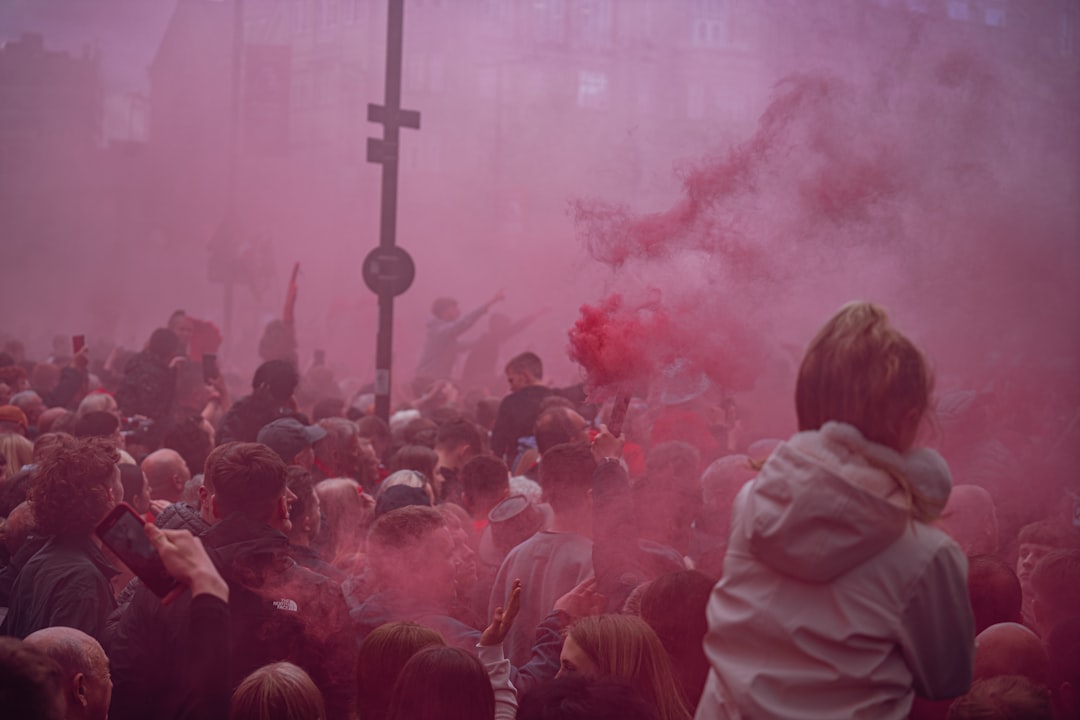 a crowd of people standing around a red smoke bomb jude bellingham, england football team, celebrating goal