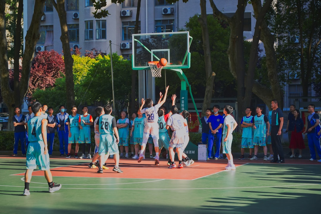 a group of young men playing a game of basketball basketball court fans cheering