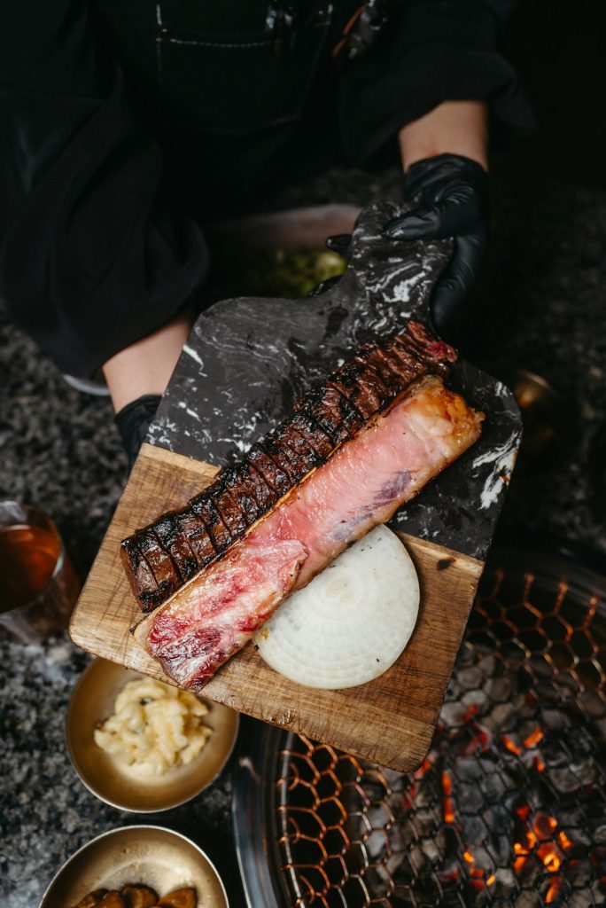 a person holding a piece of meat on a cutting board dak prescott, dallas cowboys, quarterback throwing