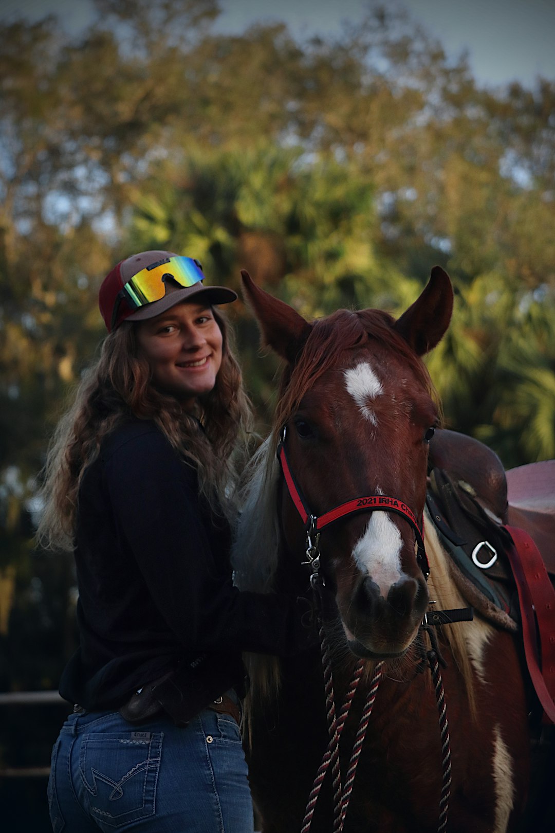 a woman standing next to a brown and white horse rachael blackmore, horse racing, jockey celebrates