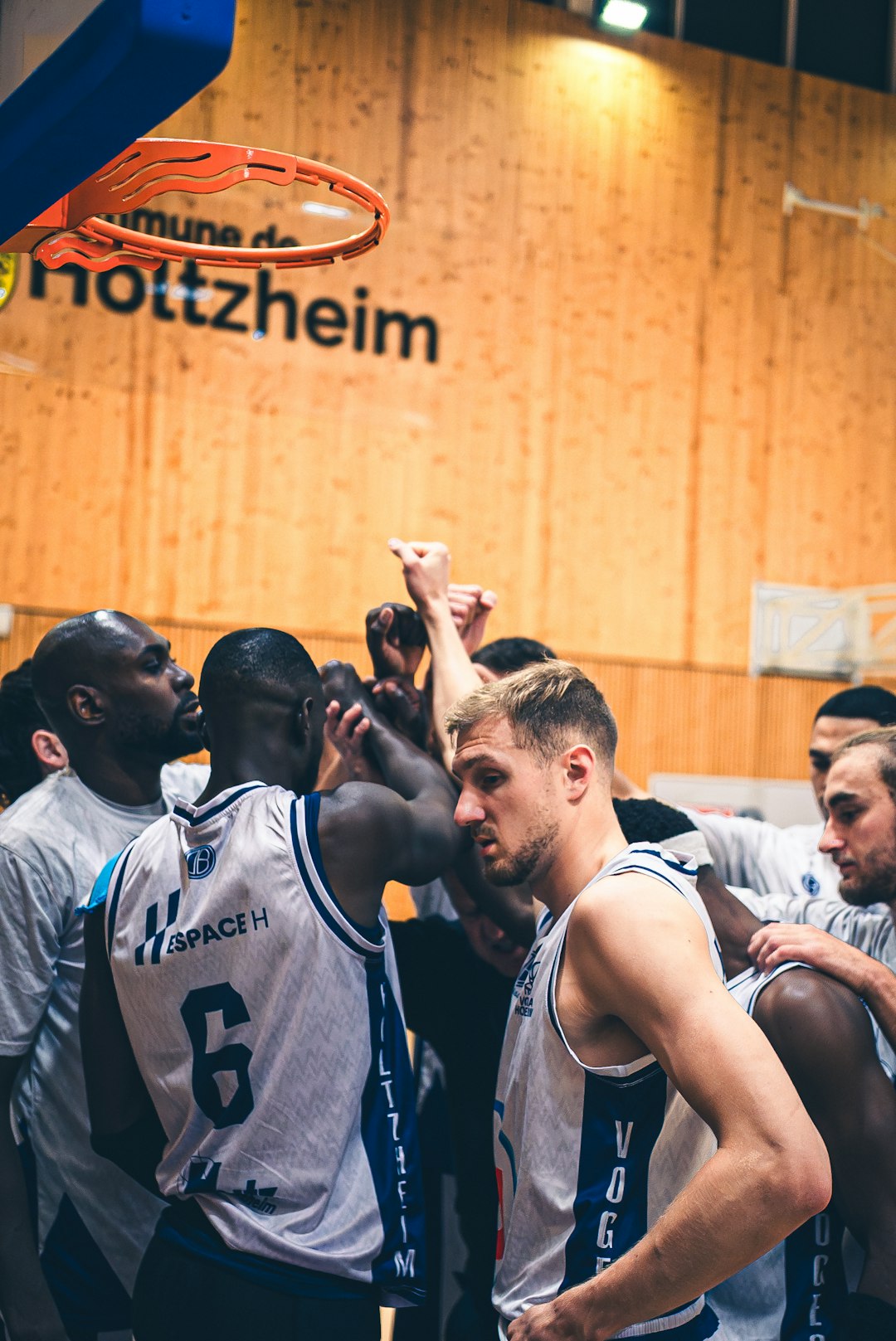 Basketball players huddle together during a game. basketball game team huddle