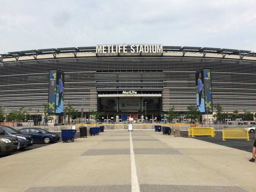 cars parked in front of building during daytime nfl draft stage, football event, sports fans