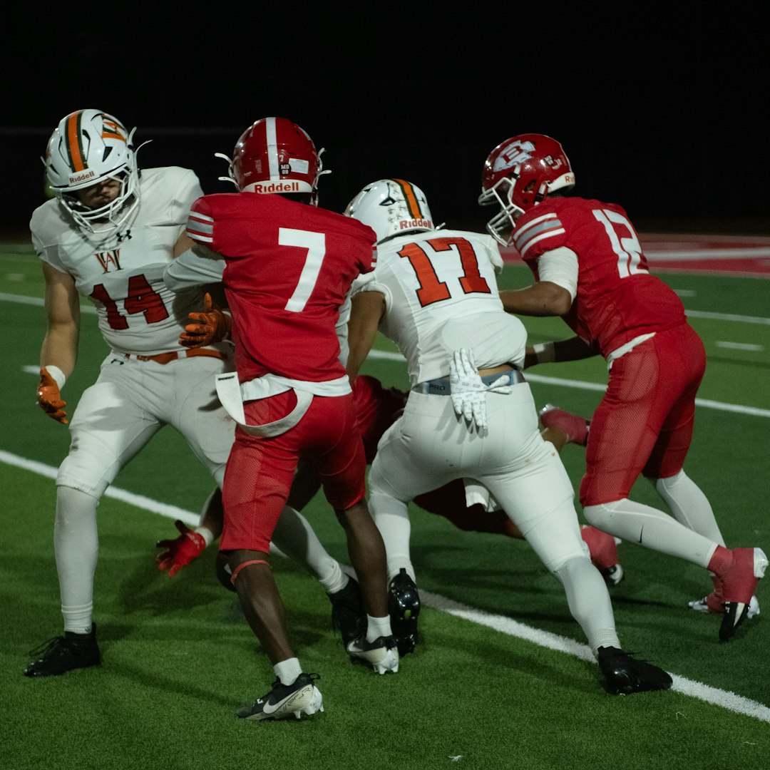 Football players in action during a game. grinnell college football game action