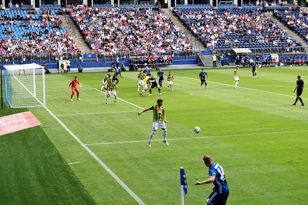 men playing soccer of soccer field during daytime fifa online, football match, stadium action