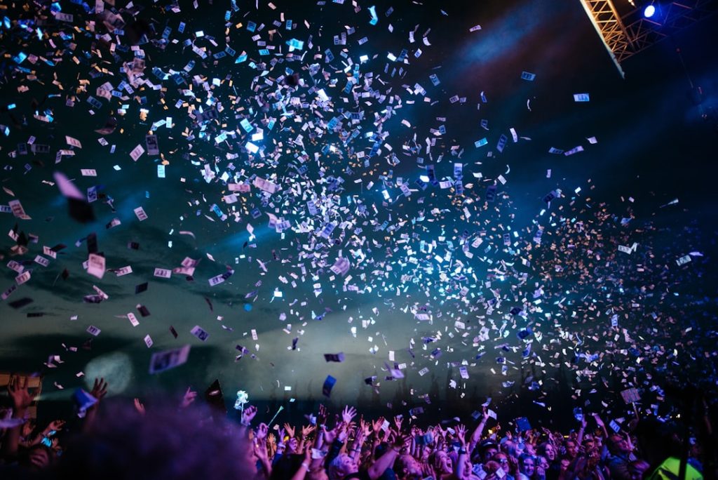 people partying with confetti nfl draft stage, football event, sports fans