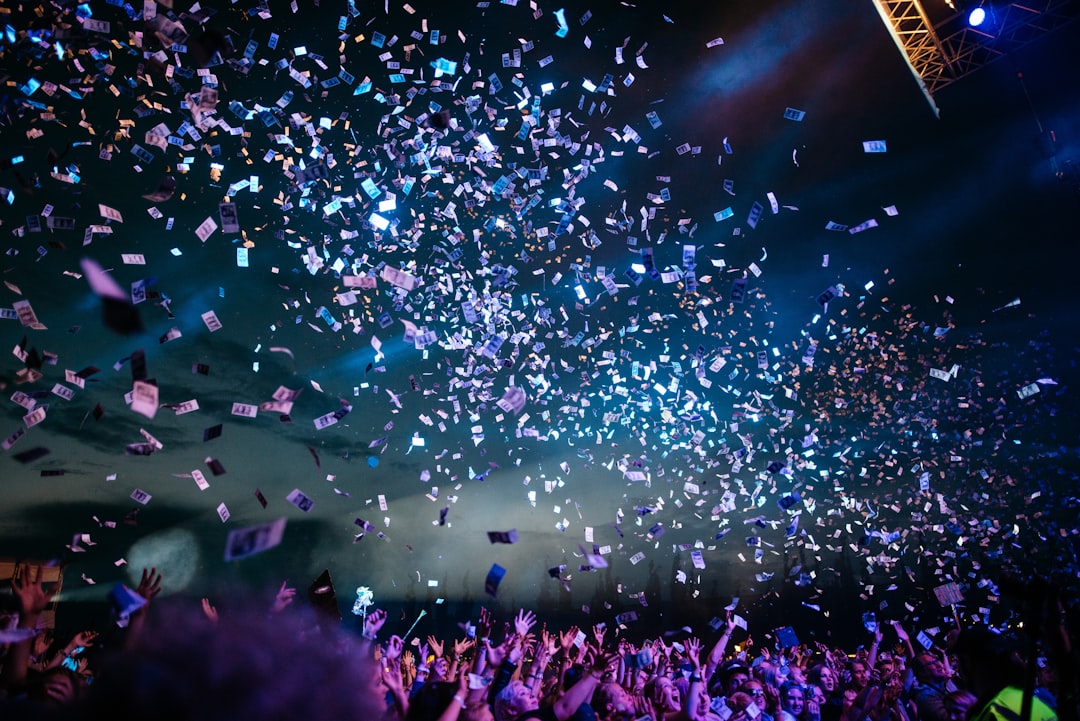 people partying with confetti nfl draft stage, football event, sports fans