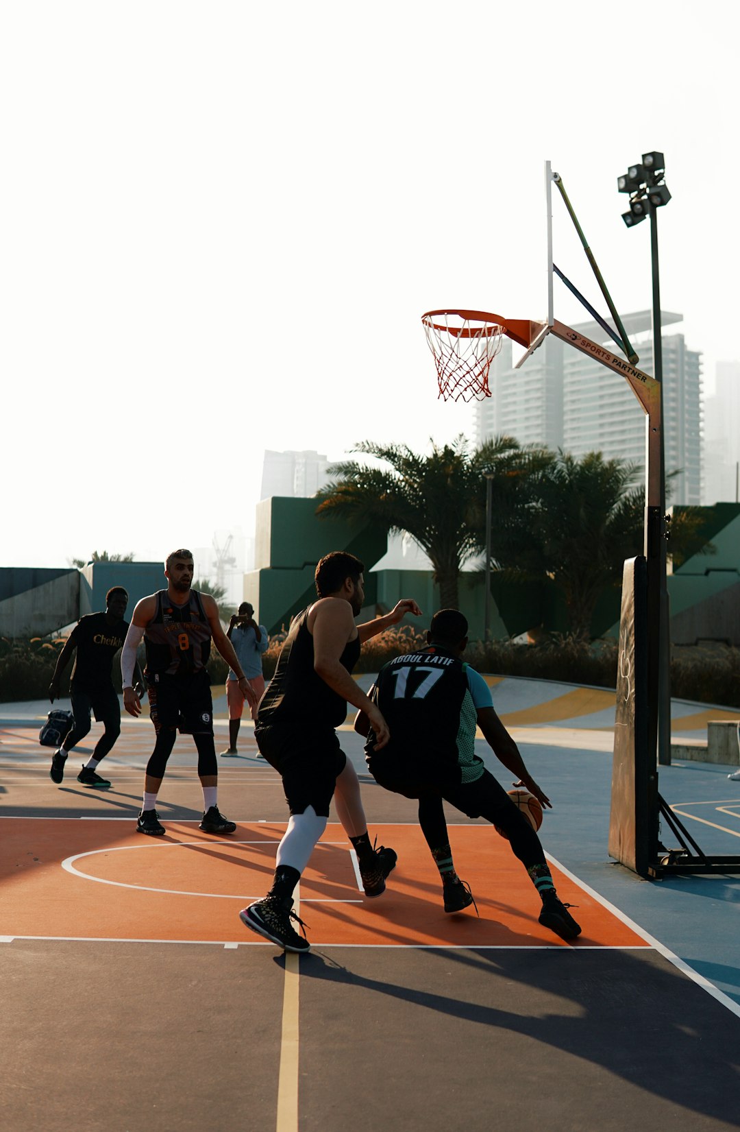 people playing basketball during daytime basketball players game shot
