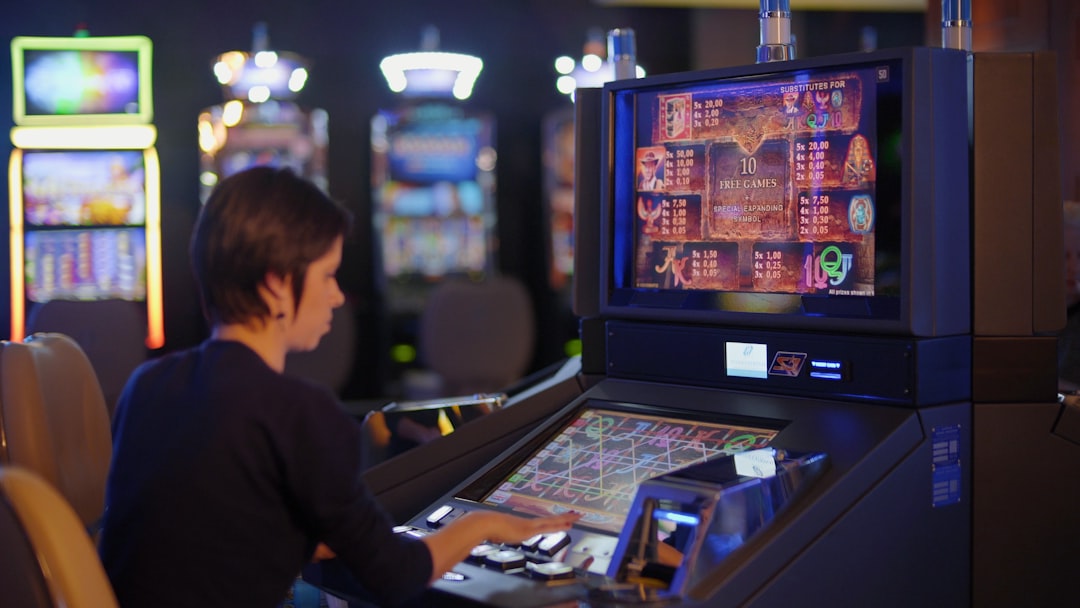 woman in black long sleeve shirt playing arcade game mobile gaming, casino slots, online entertainment