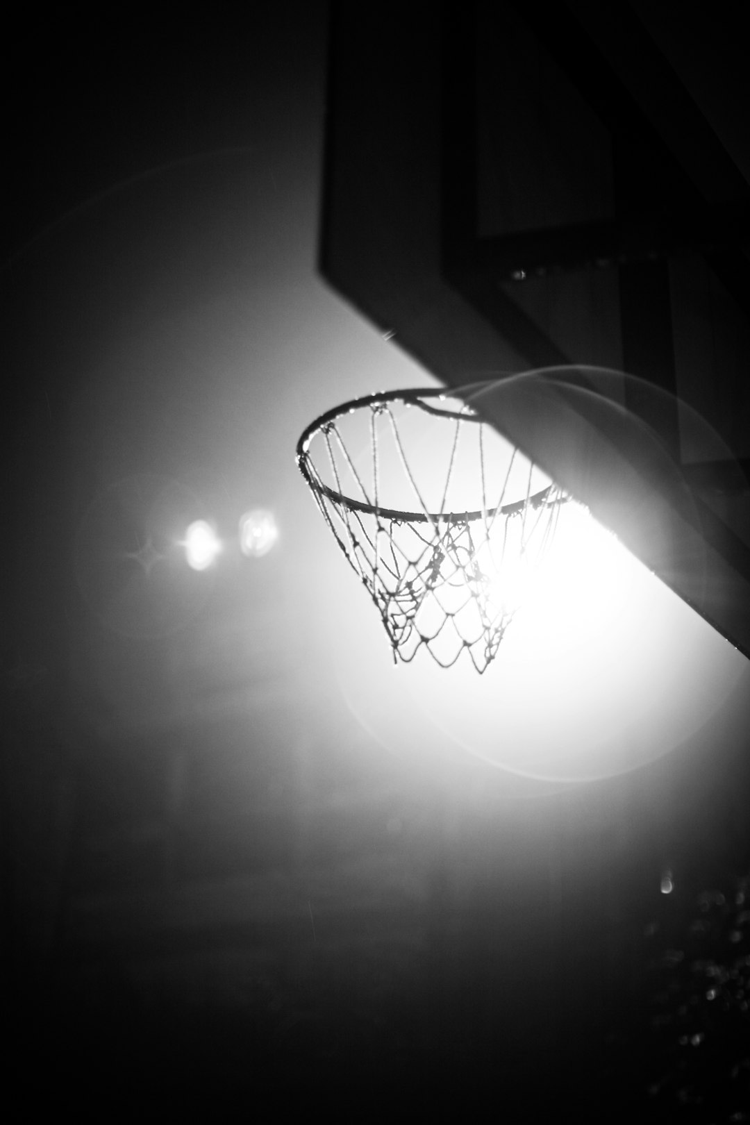 a basketball going through the hoop in the dark lebron james, kyrie irving, game 7 block, stephen curry, 2016 nba finals