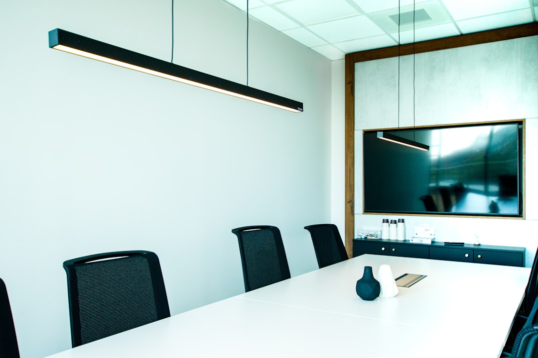 a conference room with a white table and black chairs client meeting, crm dashboard, commercial buildings