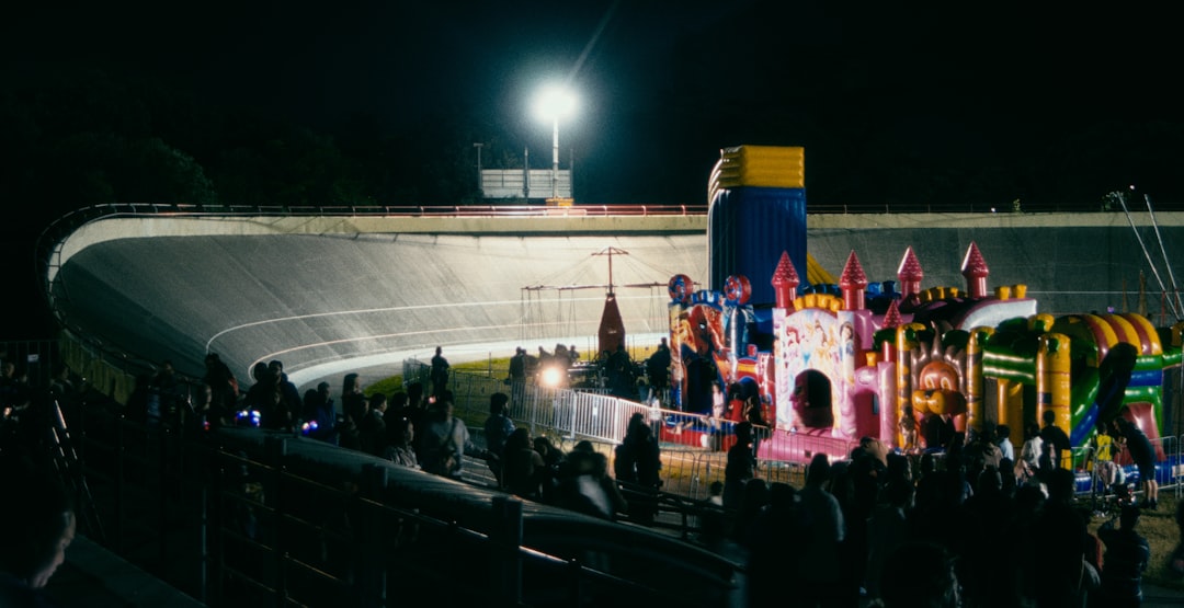 a crowd of people standing around a carnival ride touchdown celebration, 8 bit football fan, pixel art stadium