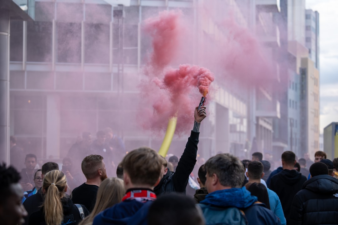 a crowd of people standing in front of a building danish football fans, waving scarves, stadium atmosphere