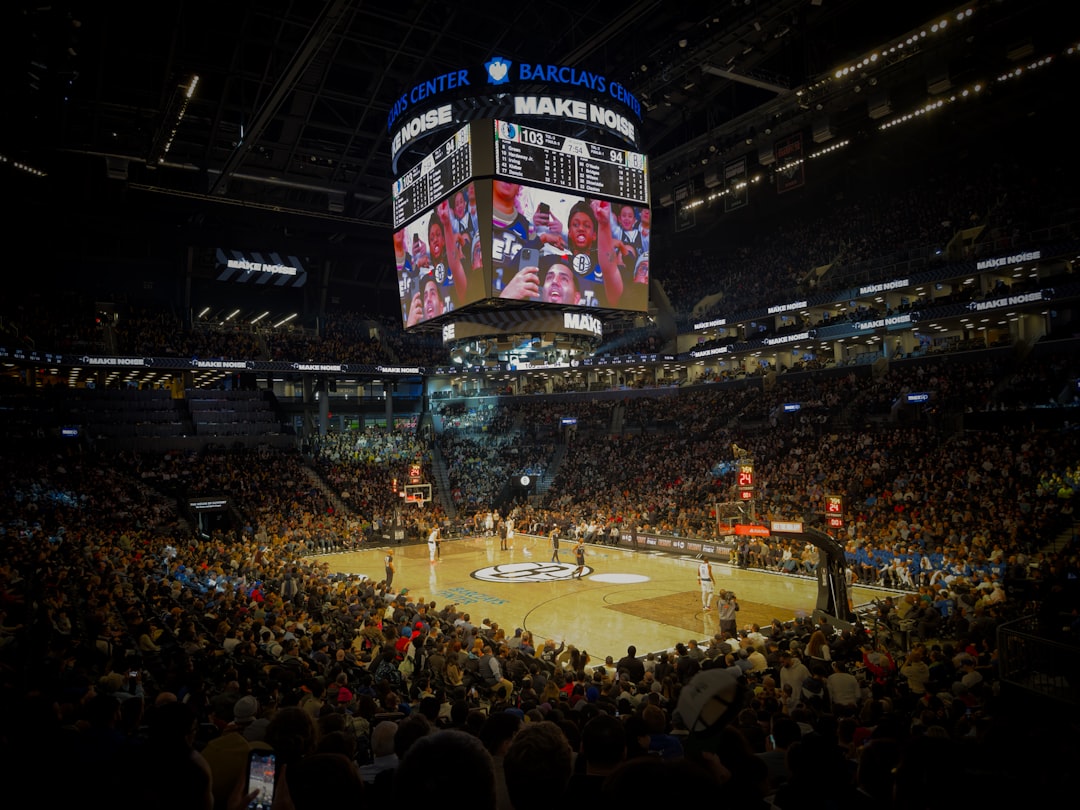 A crowd of people watching a basketball game denver nuggets vs lakers, basketball arena, nba game