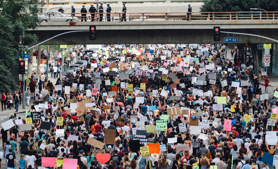 a large group of people holding up signs group outing, baseball seats, stadium crowd