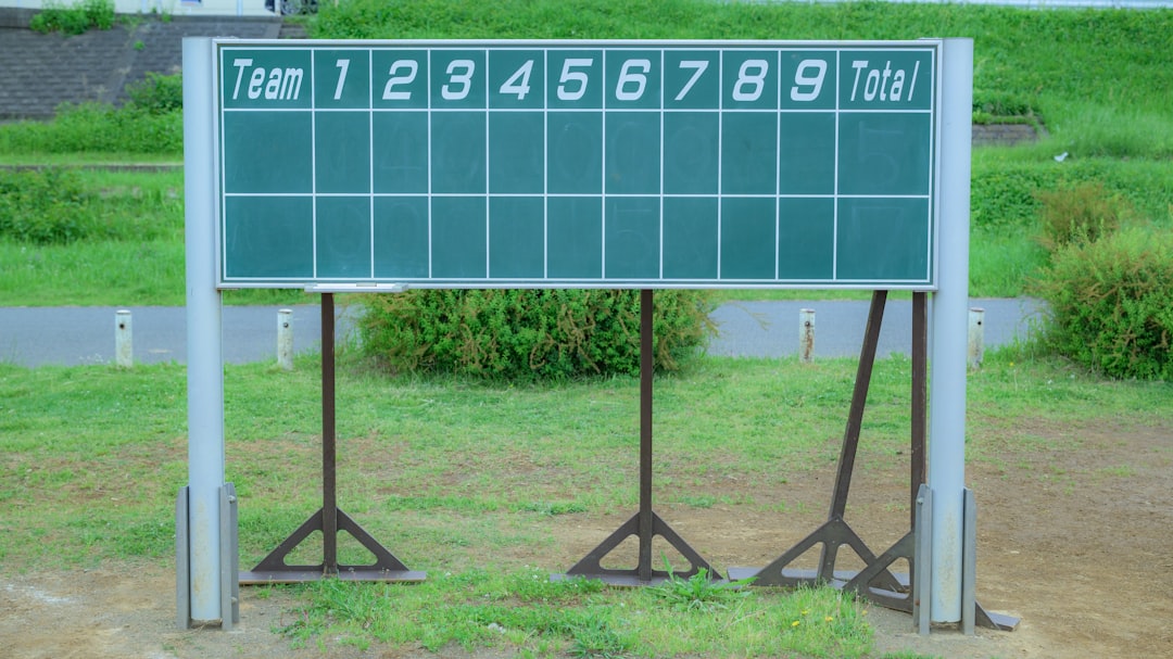 a large sign with a lot of numbers on it baseball scoreboard, final score, cheering fans