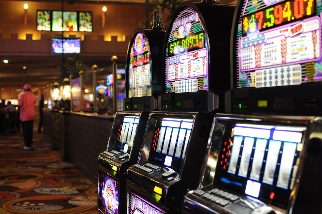 a row of slot machines in a casino new zealand, online casino, legal gambling