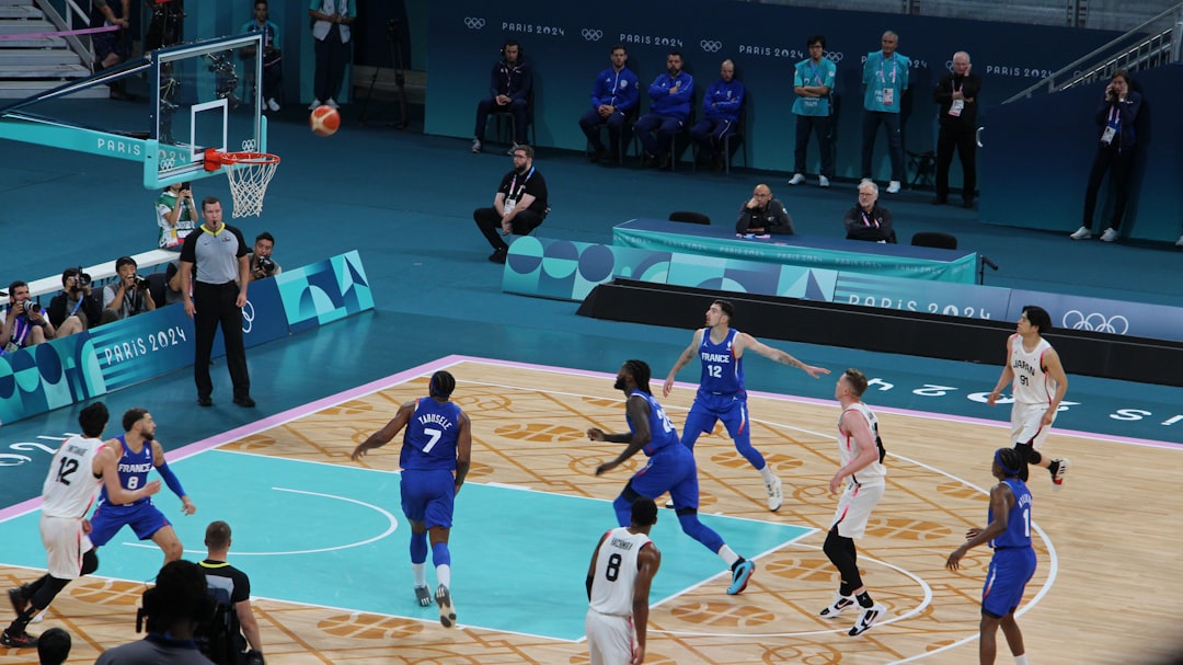 Basketball players compete on a court during a game. basketball magic moment,lebron pass,crowd reaction,nba highlight