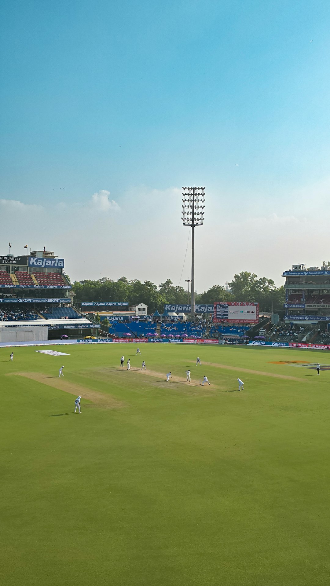 Cricket match in progress on a sunny day at stadium. cricket match streaming mobile