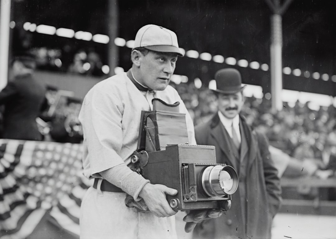 Germany Schaefer, Washington AL (baseball) holding a photographer's camera baseball scoreboard, final score, cheering fans