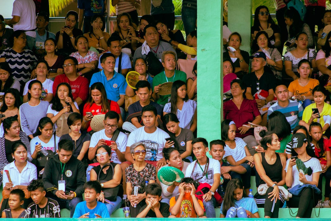 group of people taking photo happy fans, watching sports, mobile phone