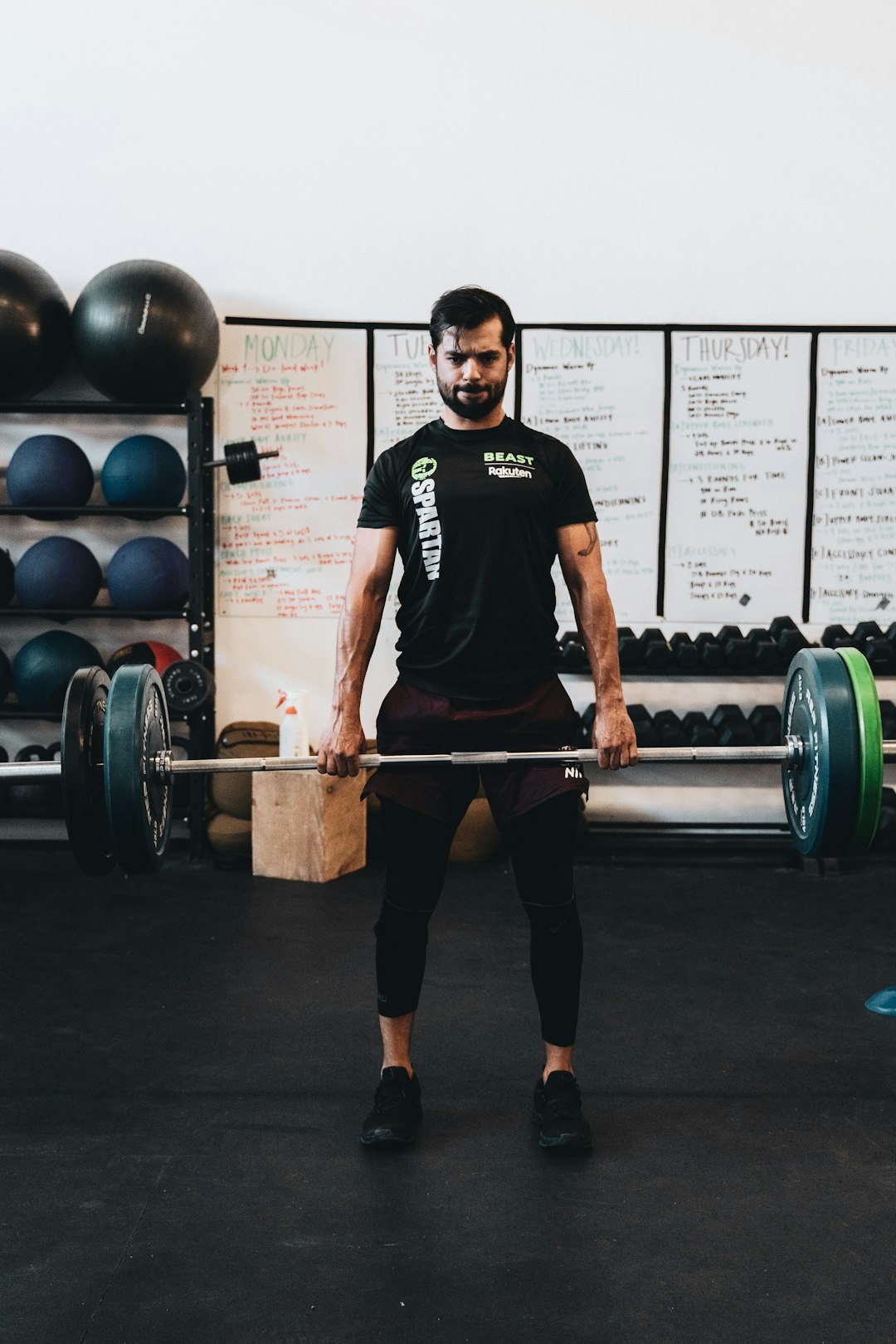 man in black crew neck t shirt and black shorts carrying barbell different sports, streaming, multiple devices