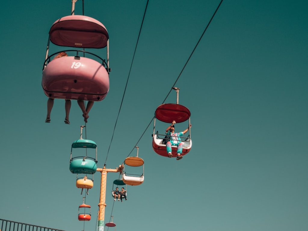 people on assorted color cable cars at daytime retro bowl gameplay, pixel football, NFL teams