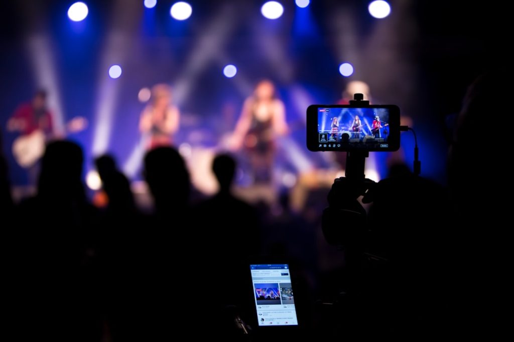 people taking videos during concert cricket match streaming mobile