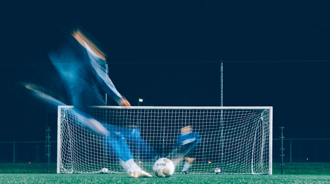 timelapse photo of soccer player kicking ball fc copenhagen stadium, brondby fans, danish football match