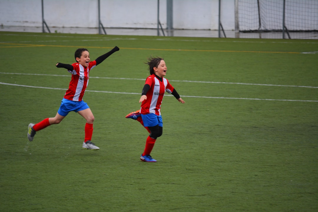 two boys running on grass field rayo vallecano, cd leganes, football match