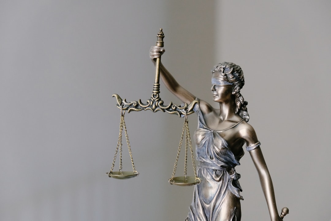 woman in dress holding sword figurine gavel, copyright law, legal documents