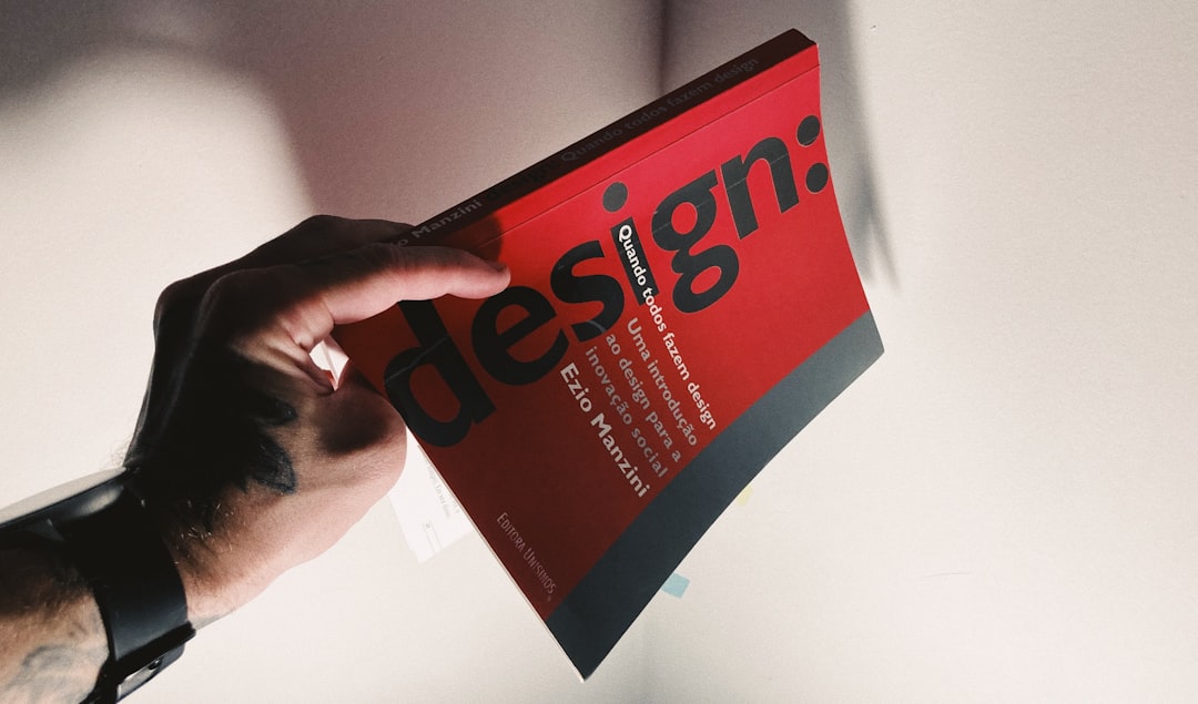 a person holding a book in their hand creative web design, component layout, visual website builder