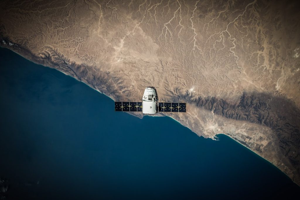 A space satellite hovering above the coastline home gym, low budget, small space