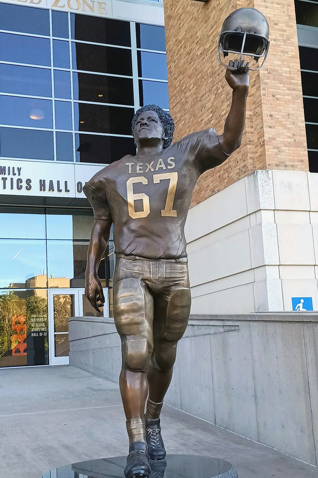 a statue of a football player holding a football caleb williams, chicago bears, nfl quarterback