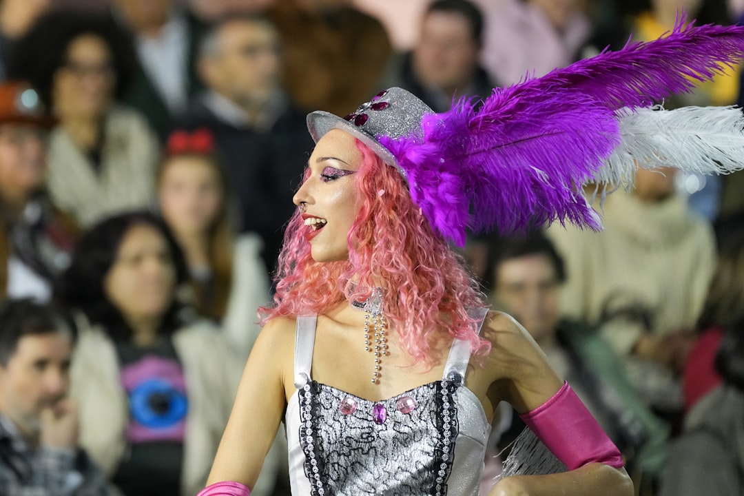 A woman in a costume smiles at a parade. celebrities,f1 race,glamour,fashion show