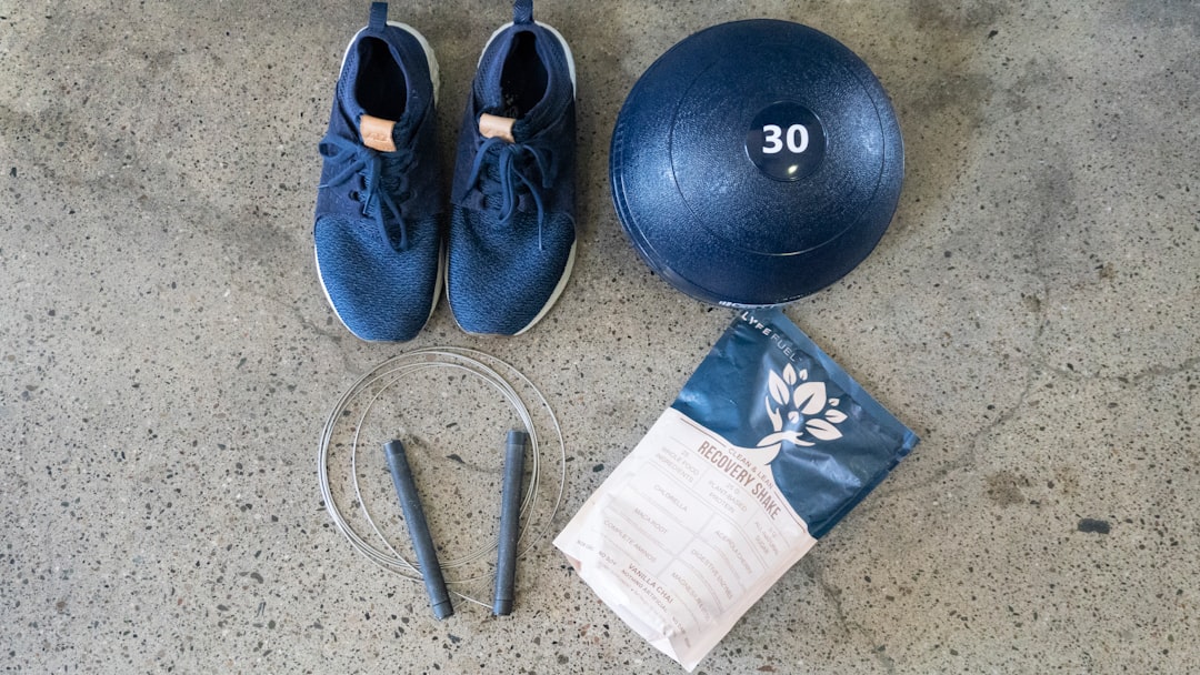 blue and white nike athletic shoes beside black round exercise ball sports fan gym, tv sports, home workout