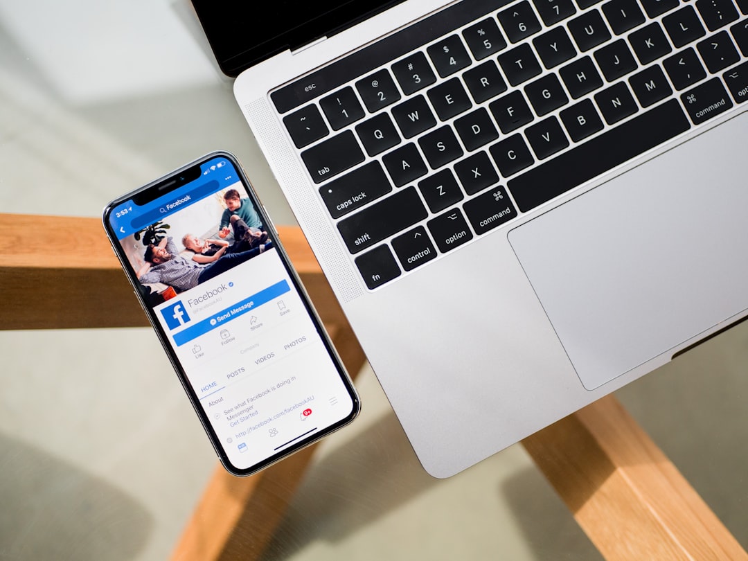 iPhone X beside MacBook mlb app, smartphone screen, restart symbol