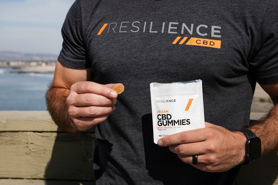 man in black crew neck t shirt holding white plastic pack nutrition coach hand, card exchange, wellness branding